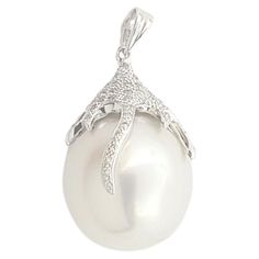 South Sea Pearl with Diamond 0.24 carat Pendant set in 18K White Gold Settings (chain not included) Width: 1.3 cm Length: 2.7 cm Total Weight: 7.07 grams South Sea Pearl Approximately: 14.5 mm "We first opened doors in 1980 when it was then situated in the vicinity of the Victory Monument; a small and modest storefront with a couple of counters. From its humble beginnings to where it stands today, our company has proven its abilities as a jeweler. Since the beginning, we have been supplying fine quality pieces to dealers, wholesalers and customers worldwide. From then till now, our business still interrelates its name with quality products and excellent service, where commitment and sincerity toward customers will always be its motto." Diamond Pendant Set, Pearl Diamond Pendant, Diamond Pendant Sets, Sea Pearl, South Seas, South Sea Pearls, Sea Pearls, Pearl Diamond, Pendant Set