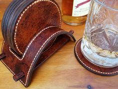 a wooden coaster and glass holder on a table