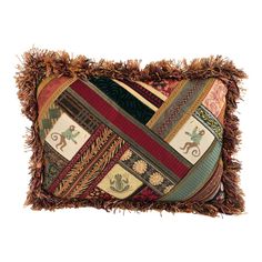 a decorative patchwork pillow with fringes and tassels on the edges,