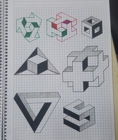 an open notebook with some drawings on top of it, including cubes and letters