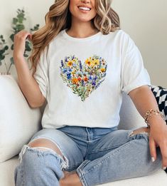 This is the PERFECT gift for the person in your life (including yourself!) that LOVES flowers! We print & ship our products from within USA. The perfect gift for Christmas, Birthdays, Holidays & Anniversaries! We use Gildan 5000 tees made from 100% soft cotton. Super comfy & great for those with sensitive skin. Runs true to size. For example, if you would usually wear a Medium, then a Medium in our tee will fit great. We offer Size Small through to 5XL. Unisex cut that looks & feels great on all Spring Heart Graphic Tee, Spring Heart-shaped Graphic Tee, Spring Tops As Gifts, Spring Gift White T-shirt, Spring Graphic Print Tops Gift, Spring Graphic Print Tops As Gift, Graphic Tee With Floral Print As A Gift, Floral Print Graphic Tee As Gift, Floral Print Graphic Tee As A Gift