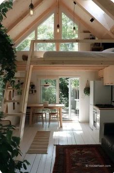 a loft bed sitting inside of a bedroom next to a kitchen