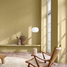 a living room with yellow walls and furniture in the corner, including a coffee table