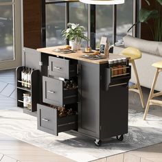 a kitchen island with drawers on wheels in front of a couch and table next to it