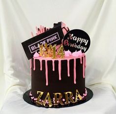 a birthday cake with pink icing and decorations on the top is for zara