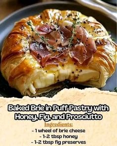 an advertisement for baked brie in puff pastry with honey, fig and prosciutto