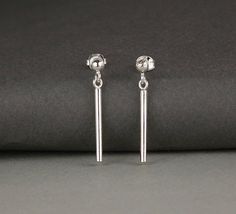 Minimal earrings. Simple stud and hanging post earrings.Sterling silver.2.9cm high.5% of all profits go the the charity Help Refugees.Also in these photos is my Silver Pebble Bracelet:https://www.etsy.com/uk/listing/580286451/winter-gift-wife-minimal-bracelet?ref=shop_home_active_1 Minimalist Dangle Plug Earrings As Gift, Minimalist Dangle Plug Earrings With Matching Pair, Silver Minimalist Dangle Plug Earrings, Minimalist Nickel-free Dangle Plug Earrings, Minimalist Hypoallergenic Dangle Plug Earrings, Minimalist Dangle Plug Earrings, Minimalist Nickel-free Drop Plug Earrings, Minimalist Hypoallergenic Drop Plug Earrings, Minimalist Hypoallergenic Drop Earrings