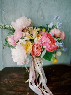 a bouquet of flowers sitting on top of a wooden table