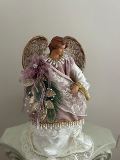 an angel figurine sitting on top of a table