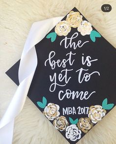 a graduation cap with the words, the best is yet to come and flowers on it