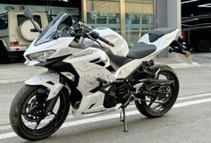 a white motorcycle parked in front of a building