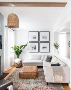 a living room filled with furniture and pictures on the wall