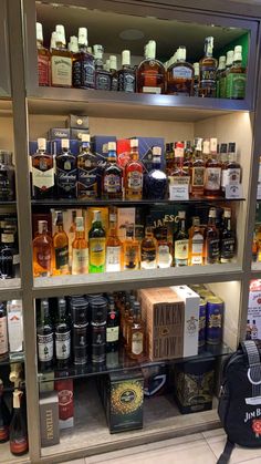 shelves filled with liquor bottles in a store