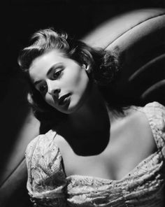 black and white photograph of a woman sitting in a chair with her eyes half closed