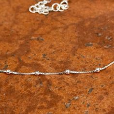 This delicate sterling silver choker necklace chain is pretty enough to wear alone, but also makes a nice complement to delicate drops or pendants. Adjustable length: 12"-16" 925 Sterling Silver purity Weight: 2.51 grams Width: .7mm .2mm round beads Lobster clasp Dainty Silver Box Chain Necklace, Silver Hypoallergenic Link Necklace, Hypoallergenic Silver Choker Necklace, Adjustable Sterling Silver Box Chain Necklace, Silver Satellite Chain Necklace With Round Pendant, Dainty Hypoallergenic Silver Chain Necklace, Adjustable Silver Satellite Chain Necklace, Sterling Silver Choker, Silver Choker Necklace