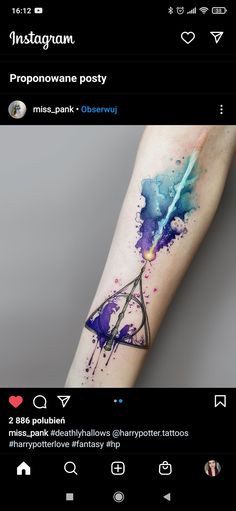 a person with a watercolor tattoo on their arm