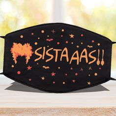 a black face mask with the word sistassa on it