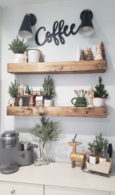 two wooden shelves filled with christmas decorations and coffee cups on top of each shelf in a kitchen