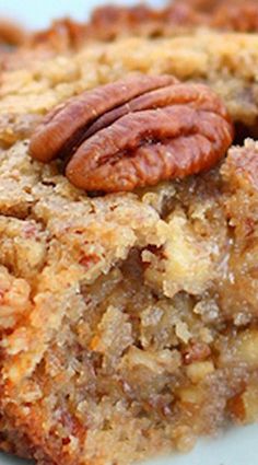 a close up of a piece of food on a plate with pecans in it