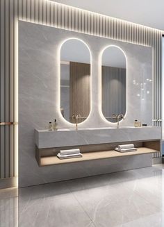 a bathroom with two sinks, mirrors and lights on the wall above them in front of a large window