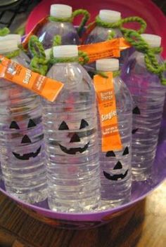 plastic water bottles with pumpkin faces on them