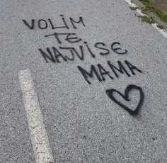 graffiti written on the pavement in front of a parking lot that says volly te navisse mama