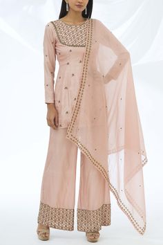 Pink short Chanderi kurta with zari embroidery and side slits. Comes with embroidered palazzo and dupatta. 
Components: 3
Fabric: Chanderi silk, cotton
Neckline: Round
Sleeve Length: Full
Color: Pink
Embroidery
Dupatta with embroidered border
Keyhole back with button loop
Closure:
Kurta: Side zip
Palazzo: Side zip - Aza Fashions Astha Narang, Embroidery Dupatta, Kurta Palazzo Set, Zari Embroidery, Pink Embroidery, Palazzo Set, Embroidered Border, Pink Shorts, Indian Design