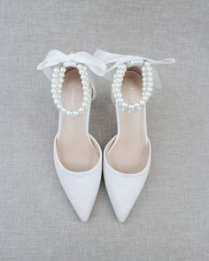 Classic satin pointy toe wedding heels with an added touch of elegance. Featuring our trinity pearl strap, which includes three rows of pearls around the ankle. Tie silky ribbon bow at the back for a secure fitting. Perfect for brides, bridal party, bridesmaids, prom, parties, or any special occasion. DETAILS: HEELS: 3 inches UPPER: Synthetic upper and lining MATERIALS: Manmade outsole ORIGIN: Imported Blue Wedding Shoes Low Heel, Wedding Heels Brides, Women Shoes Collection, Ice Blue Weddings, Blue Heels Wedding, Light Blue Heels, Blue Bridal Shoes, White Bridal Shoes, Random Products