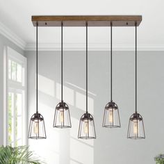 four lights hanging from the ceiling in a kitchen