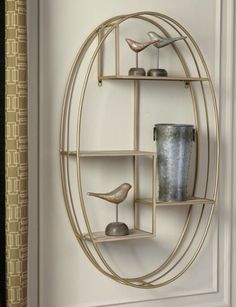 a round metal shelf with birds on it