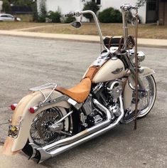 a white and tan motorcycle parked on the street