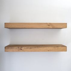 two wooden shelves against a white wall