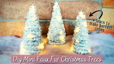 three small christmas trees sitting on top of a table next to a brick wall with the words diy mini faux fur christmas trees