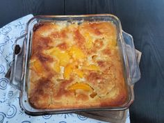 a casserole dish with oranges in it sitting on a blue and white napkin