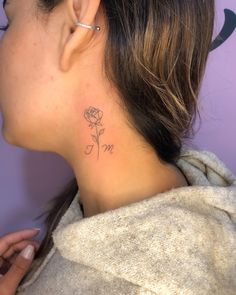 a woman with a small tattoo on her neck