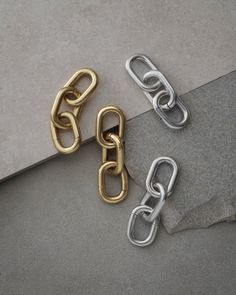 Bonded for countless wears, our Galen Chain Hangers are boldly balanced for your industrial expressions. Hangers comprising double or triple-linked cable chains in gold, silver or two-toned combinations to lock down grunge grandeur for all genders at any occasion. Sold as a pair. Recommended for stretched piercings 4mm (6g) and above. Each piece is lovingly crafted by hand, under ethical working conditions. Please allow for minor imperfections that are true to handcrafted jewelry. No two pieces Metal Chain Ring With Link Shape, Metal Chain Ring With Gold Link Chain, Gold Metal Chain Link Ring, Gold Chain Link Ring Made Of Metal, Modern Metal Chain Link Ring, Modern Metal Link Chain Ring, Oval Link Chain Ring In Metal, Metal Oval Link Chain Ring, Modern Metal Chain Ring