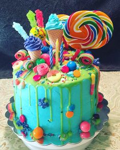 a birthday cake decorated with candy and lollipops