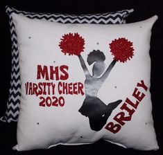 two pillows with cheerleaders on them, one is white and the other is red