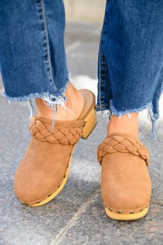 Take cute to a whole new level this season in the Morel Braided Clogs In Brown! A smooth faux leather shapes a rounded toe with braided detail and wooden sole decorated in metal studs. Pair these cute clogs with all your fall fits for a complete look! MaterialFaux suede leatherNatural wood clogLightweightTrue to size Approx. 2 3/4" heel Keywords: Clog, Mule, Braided, Brown, Shoe Fall Fits, Brown Shoe, Mule, Jumpsuit Dress, New Product, Sale Items, Stylish Outfits, Clogs, Lounge Wear