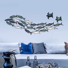 a living room filled with furniture and lots of fish on it's back wall