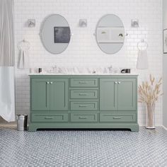 a bathroom with two sinks and mirrors on the wall