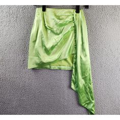 a green skirt hanging on a wall