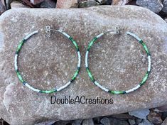 "Here's a set of green and white beaded hoop earrings. They are 2\" around.  Great contrasting colors. Beautiful earrings for everyday wear.  You can wear them to work or going out. This would make a great gift for someone special or a treat for yourself. Handmade is from the Heart ❤️ Handmade in Arizona 🇺🇸 Thank you for stoping by.  Have a great day." Hoop Earrings Diy, Black Hoops Earrings, Beaded Necklace Designs, Diy Wire Jewelry, Pattern Ideas, Handmade Jewelry Diy, Beaded Hoop Earrings, Beaded Hoops, Seed Bead Bracelets