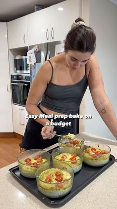 a woman preparing food on top of a black tray