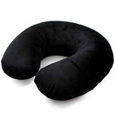 a black neck pillow sitting on top of a white table