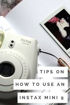 an instax camera sitting on top of a table next to a polaroid with the words tips on how to use an instax mini 9