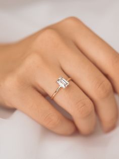 a woman's hand with a diamond ring on it