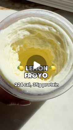 a person is holding a cup filled with yogurt and the words lemon froyo on it