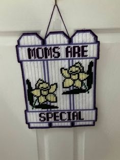 a cross stitch sign that says moms are special hanging on a door handle in front of a white door