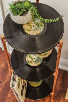 an old record player turned into a planter on top of it's stand